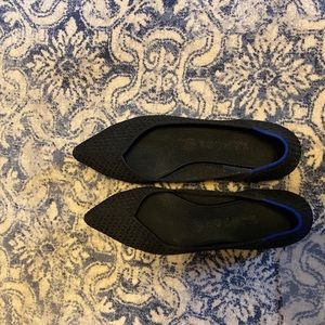 Rothy’s black pattern pointed toe shoes.